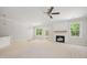 Spacious living room with fireplace, a ceiling fan, and access to the backyard at 90 Purslane Dr, Franklinton, NC 27525