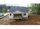 New construction home featuring a covered rear porch and light vinyl siding at 90 Purslane Dr, Franklinton, NC 27525