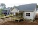 New construction home boasts a covered back porch, light siding, and grey roof at 90 Purslane Dr, Franklinton, NC 27525
