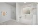 Bright bathroom featuring a glass-enclosed shower, soaking tub, and black-and-white tiled floor at 106 Teak Cir, Garner, NC 27529