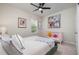 This bedroom features neutral walls, a ceiling fan, and artwork throughout the space at 106 Teak Cir, Garner, NC 27529