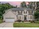 Charming two-story home with neutral siding, a well-manicured lawn and an attached two-car garage at 106 Teak Cir, Garner, NC 27529