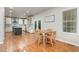 Bright kitchen with white cabinets, island, stainless steel appliances, and an adjacent dining area at 106 Teak Cir, Garner, NC 27529