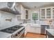 Well-appointed kitchen with custom cabinets, stainless steel appliances, and a farmhouse sink at 106 Teak Cir, Garner, NC 27529