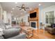 Spacious living room featuring hardwood floors, fireplace, and open layout connecting to the kitchen at 106 Teak Cir, Garner, NC 27529