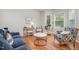 Cozy living room with hardwood floors, comfortable seating, and natural light through the window at 106 Teak Cir, Garner, NC 27529