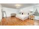 Bright main bedroom featuring hardwood floors, a chandelier, and elegant furnishings at 106 Teak Cir, Garner, NC 27529