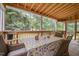 This screened porch offers an inviting dining space with a wood ceiling, table, and seating for outdoor enjoyment at 106 Teak Cir, Garner, NC 27529