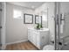 Bright bathroom with a double vanity, stylish mirrors, and modern fixtures at 107 Port Charlotte Ct, Sanford, NC 27330