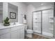 This well lit bathroom features a single vanity, a shower with glass door, and modern fixtures at 107 Port Charlotte Ct, Sanford, NC 27330