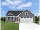 Charming single Gathering home with gray siding, a red door, and a well-manicured front lawn at 107 Port Charlotte Ct, Sanford, NC 27330