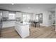 Spacious kitchen with white cabinetry, stainless steel appliances, and open dining area at 107 Port Charlotte Ct, Sanford, NC 27330