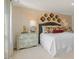 Stylishly decorated bedroom showcasing a bed with a decorative headboard and accent wall at 1105 Ursa Major Ct, Wendell, NC 27591