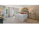 Spacious bedroom with brick accent wall, bathed in natural light from large windows at 1105 Ursa Major Ct, Wendell, NC 27591