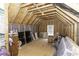 Unfinished attic space with exposed wooden beams and plywood subfloor, ready for customization at 1108 Agio Ct, Zebulon, NC 27597