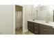 Bright bathroom with double sink vanity, modern fixtures, and tiled shower with curtain at 1108 Agio Ct, Zebulon, NC 27597