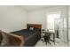 Comfortable bedroom featuring a wooden bed frame and a desk with a rolling chair at 1108 Agio Ct, Zebulon, NC 27597