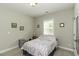 Cozy bedroom with neutral walls, a window with natural light, and carpeted floor at 1108 Agio Ct, Zebulon, NC 27597