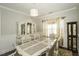 Elegant dining room with a decorative cabinet, chandelier, and matching chairs at 1108 Agio Ct, Zebulon, NC 27597