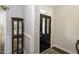 Charming entryway features a glass cabinet and a dark front door with glass panes at 1108 Agio Ct, Zebulon, NC 27597