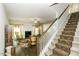 Welcoming living room with a fireplace and elegant furnishings, viewed from the staircase at 1108 Agio Ct, Zebulon, NC 27597