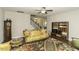 Spacious living room featuring a grand grandfather clock and a staircase at 1108 Agio Ct, Zebulon, NC 27597