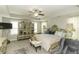 Bright main bedroom with a tray ceiling, ornate furniture, and a ceiling fan at 1108 Agio Ct, Zebulon, NC 27597