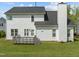 Image of the house showing a white exterior, gray deck, and green lawn in the backyard at 113 Laurel Branch Dr, Cary, NC 27513