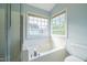 Bathroom featuring a soaking tub with a shower and multiple windows at 113 Laurel Branch Dr, Cary, NC 27513