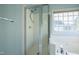 Bright bathroom featuring a glass enclosed shower and soaking tub with large grid window at 113 Laurel Branch Dr, Cary, NC 27513