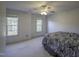 Spacious bedroom featuring two windows and a ceiling fan at 113 Laurel Branch Dr, Cary, NC 27513