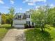 Charming two-story home featuring a two-car garage and a beautifully landscaped front yard with mature trees at 113 Laurel Branch Dr, Cary, NC 27513