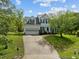 Charming two-story home featuring a two-car garage and a beautifully landscaped front yard with mature trees at 113 Laurel Branch Dr, Cary, NC 27513