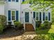 Inviting front entrance with brick steps, manicured shrubs and a freshly painted door at 113 Laurel Branch Dr, Cary, NC 27513