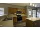 Classic kitchen with stainless appliances, wood cabinets, and an adjacent eat-in area at 113 Laurel Branch Dr, Cary, NC 27513