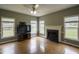 Cozy living room with a fireplace, large windows, and hardwood floors at 113 Laurel Branch Dr, Cary, NC 27513