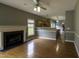 Open living space with fireplace and hardwood floors that flows into the kitchen at 113 Laurel Branch Dr, Cary, NC 27513