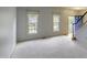 Bright living room with neutral carpet, large windows, and a glimpse of the entry at 113 Laurel Branch Dr, Cary, NC 27513
