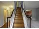 Elegant wooden staircase with white railings, ascending to the upper level of the house at 113 Laurel Branch Dr, Cary, NC 27513