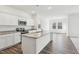 Modern kitchen featuring an island, white cabinets, stainless steel appliances, and granite countertops at 115 Gladstone Loop, Clayton, NC 27520