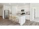 Modern kitchen with bar stool seating, stainless steel appliances, and granite counter tops at 115 Gladstone Loop, Clayton, NC 27520