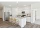 Staged kitchen has bar stool seating, stainless appliances, and granite counter tops at 115 Gladstone Loop, Clayton, NC 27520