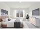 A tastefully staged bedroom offers modern decor and bright natural lighting at 115 Gladstone Loop, Clayton, NC 27520