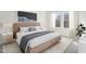 A staged bedroom with a comfortable bed, artwork, and natural light at 115 Gladstone Loop, Clayton, NC 27520