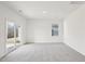 Spacious carpeted bedroom with a sliding glass door and a window bringing in natural light at 125 Gladstone Loop, Clayton, NC 27520