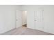 Neutral bedroom features light carpet, white walls, and a doorway leading to other rooms at 125 Gladstone Loop, Clayton, NC 27520