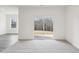 Bright living area with sliding glass door and plush carpet, offering a tranquil view at 125 Gladstone Loop, Clayton, NC 27520