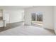 Open-concept living area with light-filled with sliding glass door and modern flooring at 125 Gladstone Loop, Clayton, NC 27520