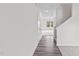 Long hallway with hardwood floors leading into a carpeted living space at 129 Gladstone Loop, Clayton, NC 27520