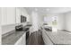 Modern kitchen showcasing a large island, granite countertops, and white cabinets at 129 Gladstone Loop, Clayton, NC 27520